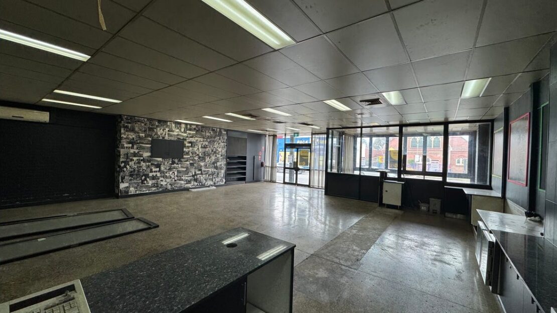 Open-plan showroom space with large windows and customer counter Sydney Road Coburg. Internal view of 293-295 Sydney Rd Coburg